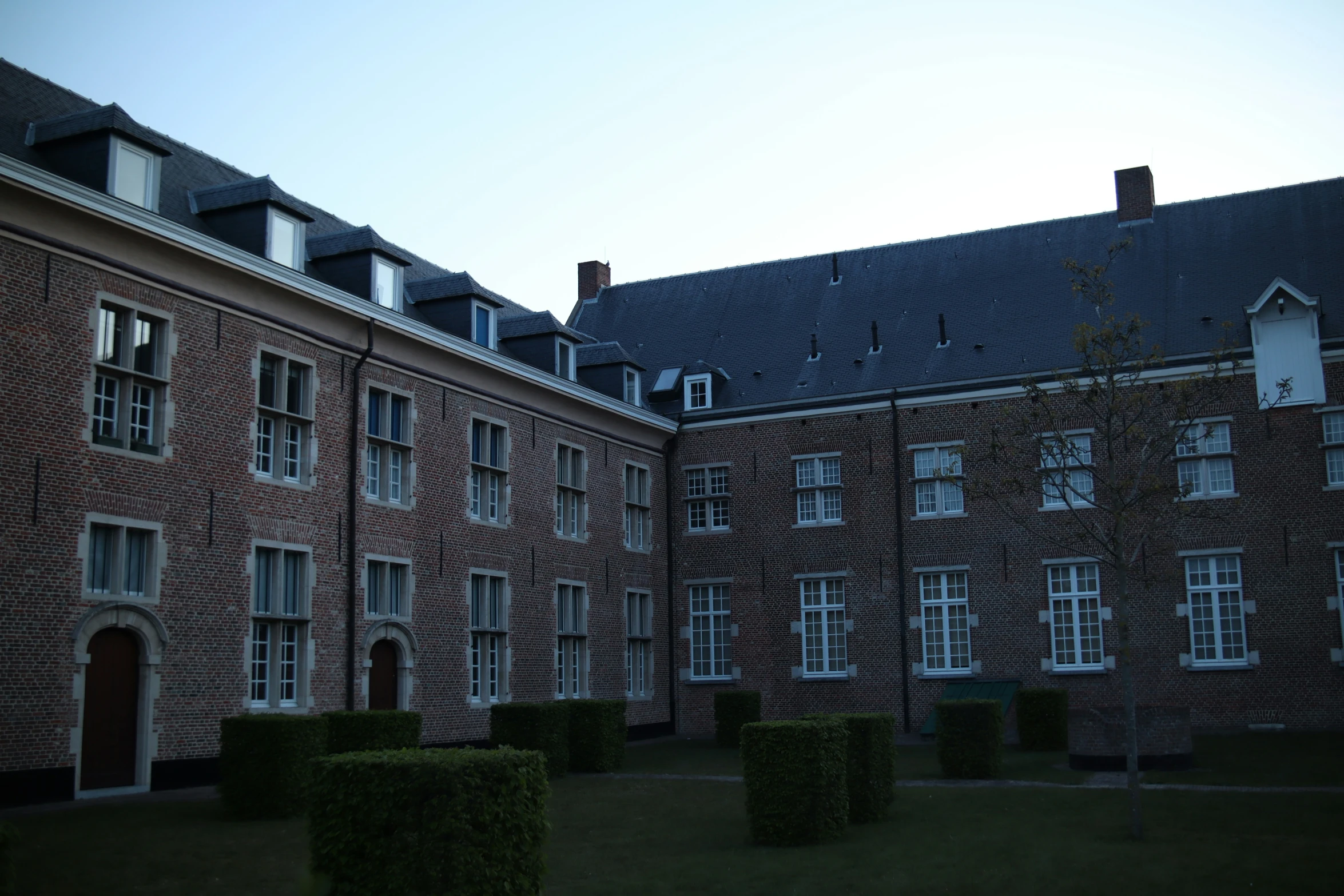 tall brown brick building with windows in the top