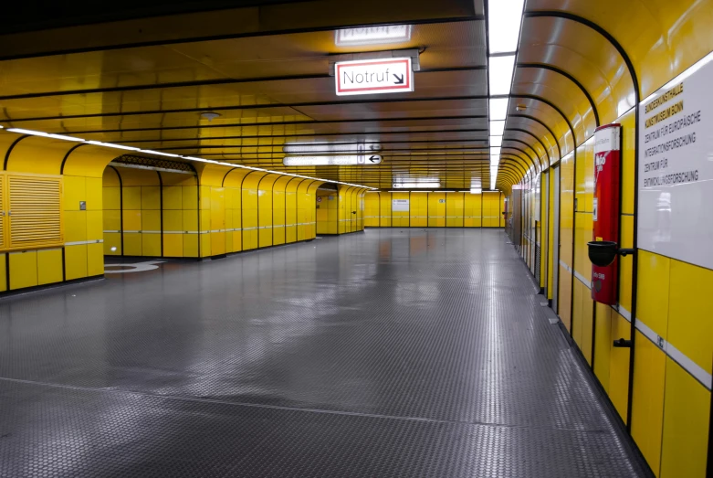 an empty yellow parking garage with metal floor