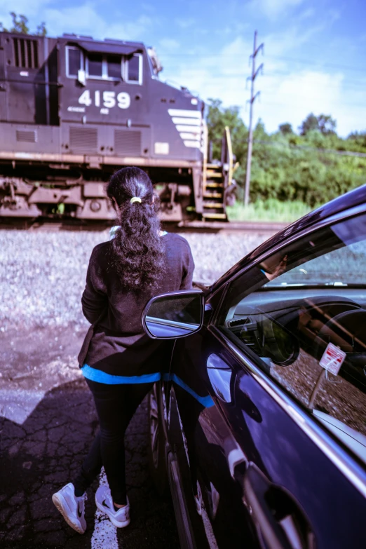 a man with a mask leaning on a car