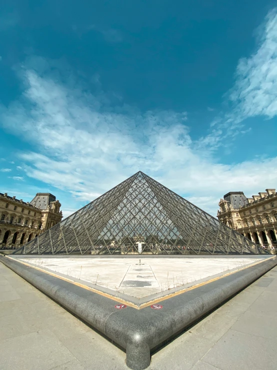 an empty outdoor space with a very large pyramid