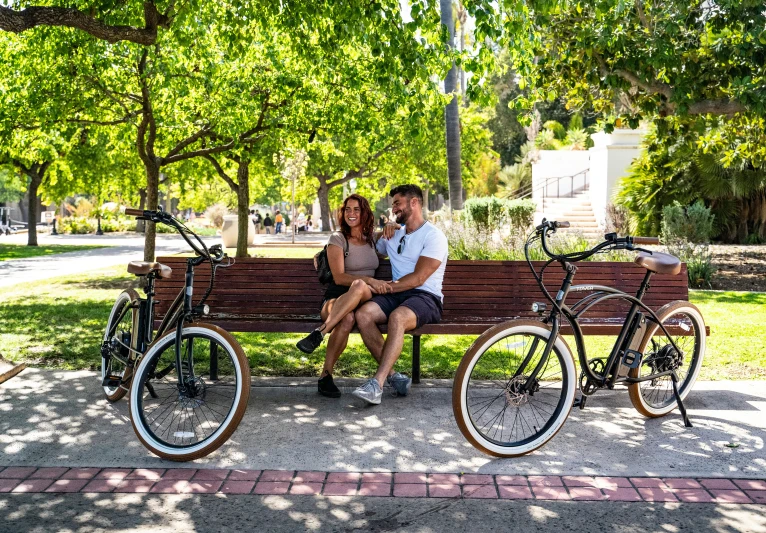 there are two bikes and a bench that are next to each other