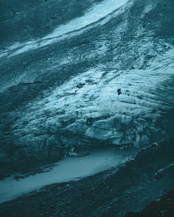 some hills and water on an ocean with snow