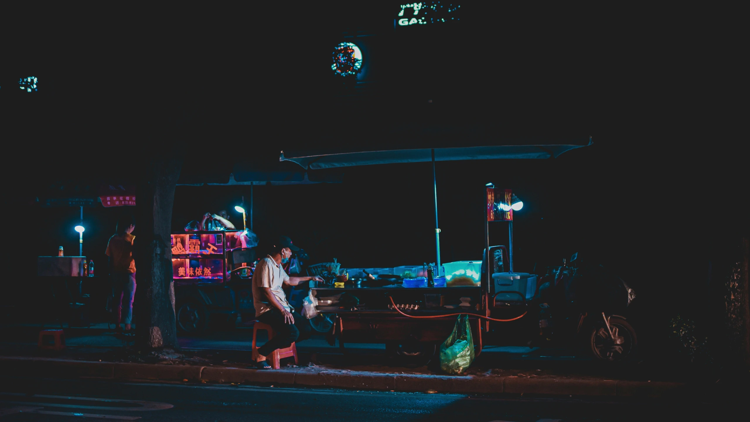 two men are washing a car with a pump