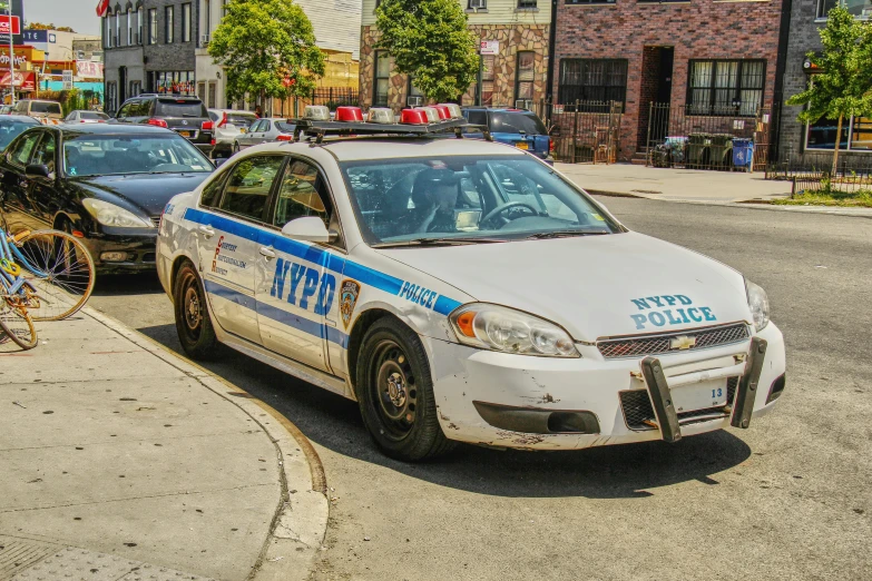 an adult sits in the drivers seat of a police car