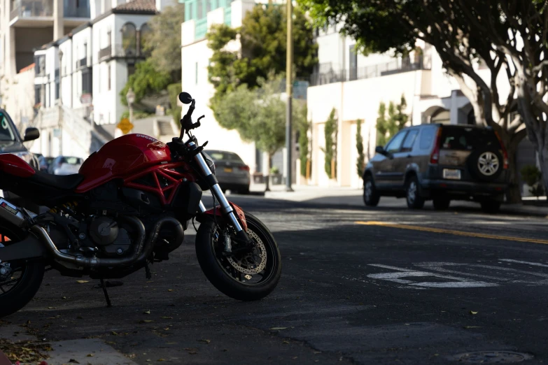 a red motorcycle parked on the side of the road