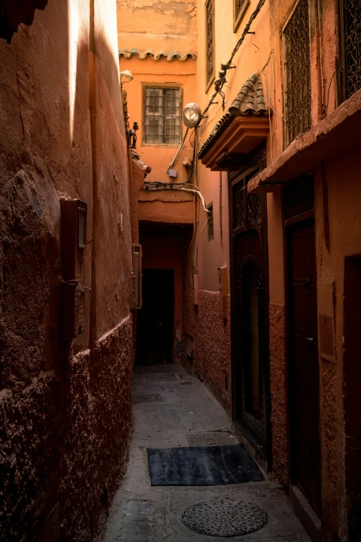 a narrow alley with a door and windows
