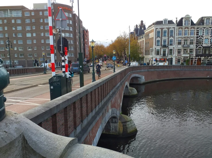 a bridge crossing a river with some buildings on either side