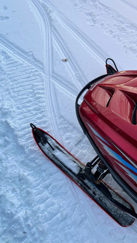 two sleds are pulled along in the snow