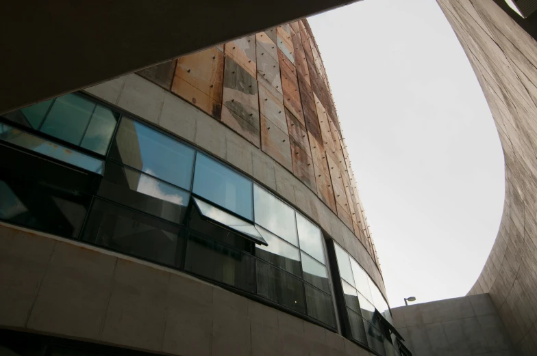 looking up at a building through an angled view mirror
