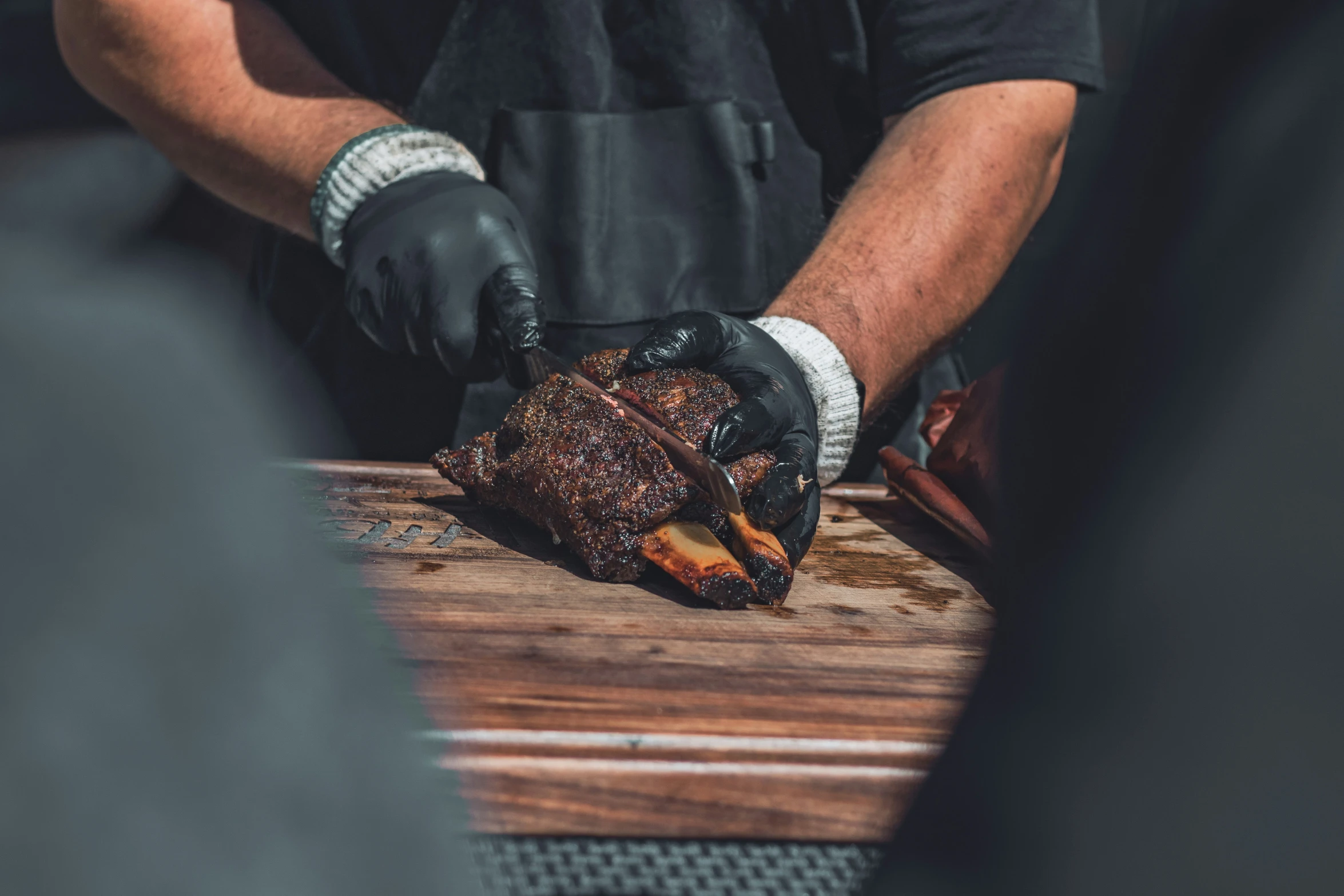 a chef carving a roast beef on a board