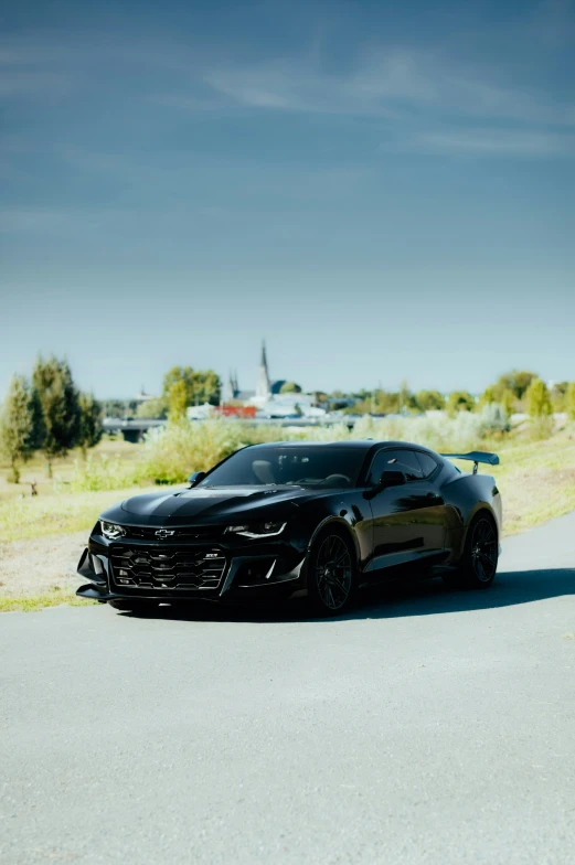 a sleek black sports car parked on the side of the road