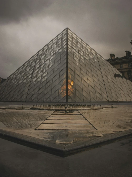 the large glass pyramid of the museum at dusk