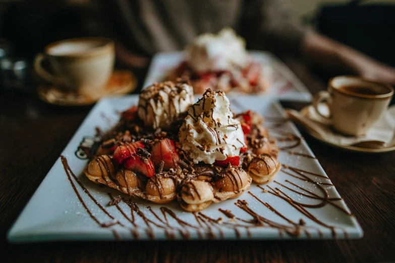 a white plate topped with waffles covered in chocolate sauce