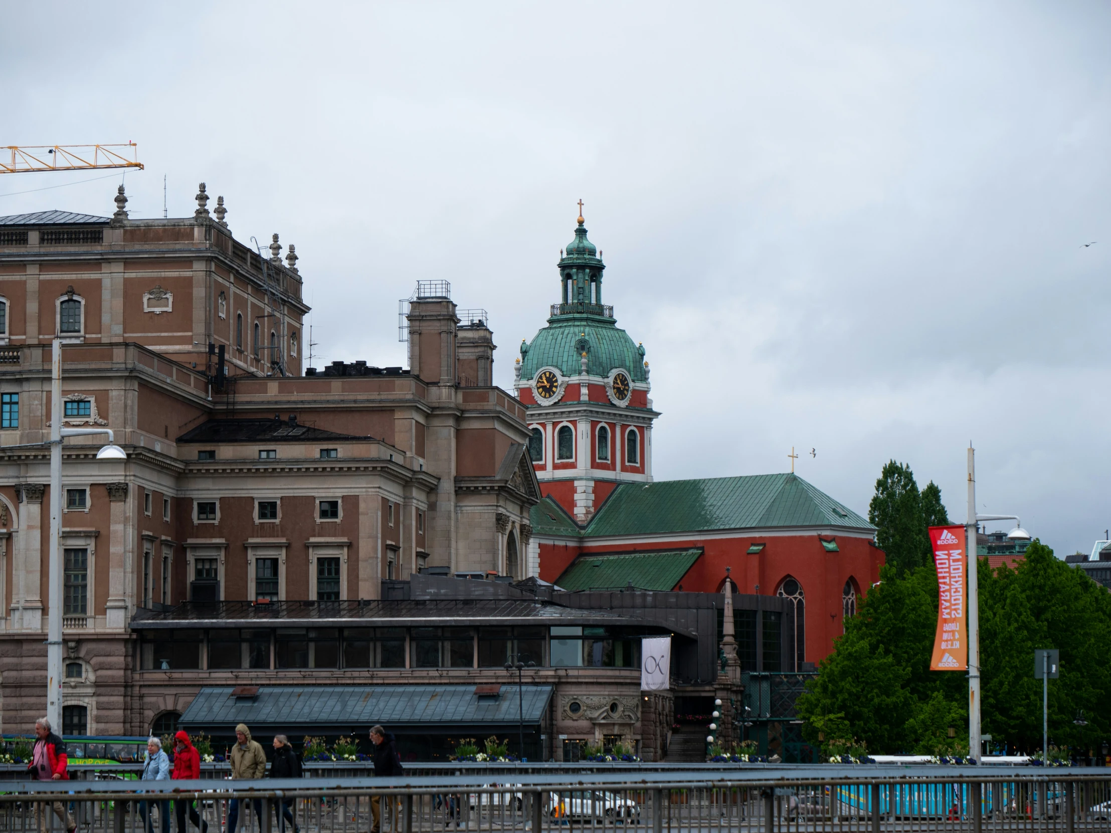 a building with people walking past it, in the foreground