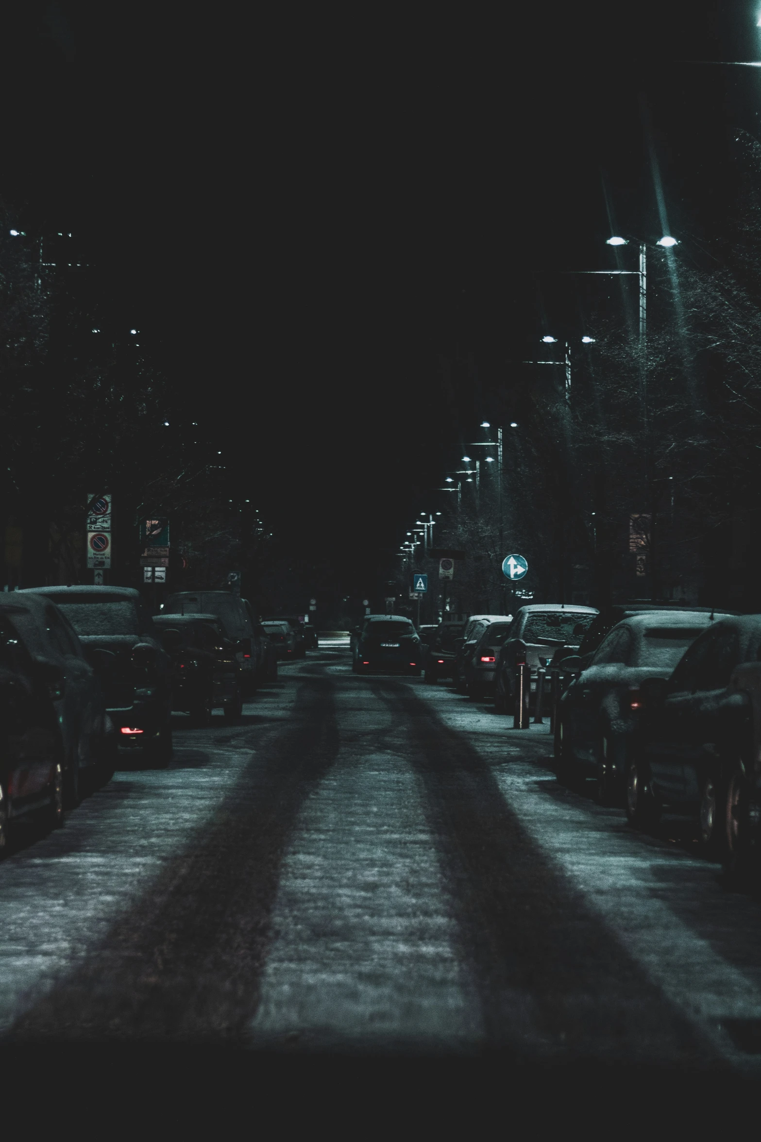 a bunch of cars on the side of the road at night