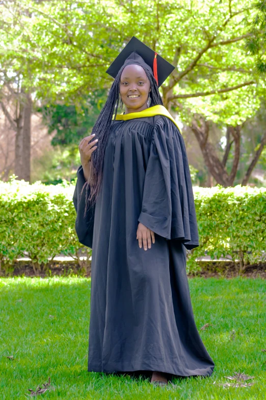 a woman in a graduation gown posing for a po