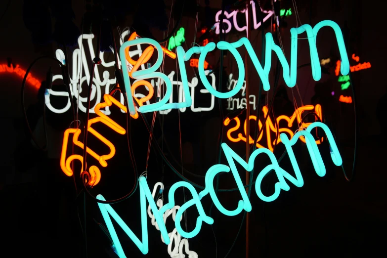 a group of colorful neon signs sitting on top of a black background