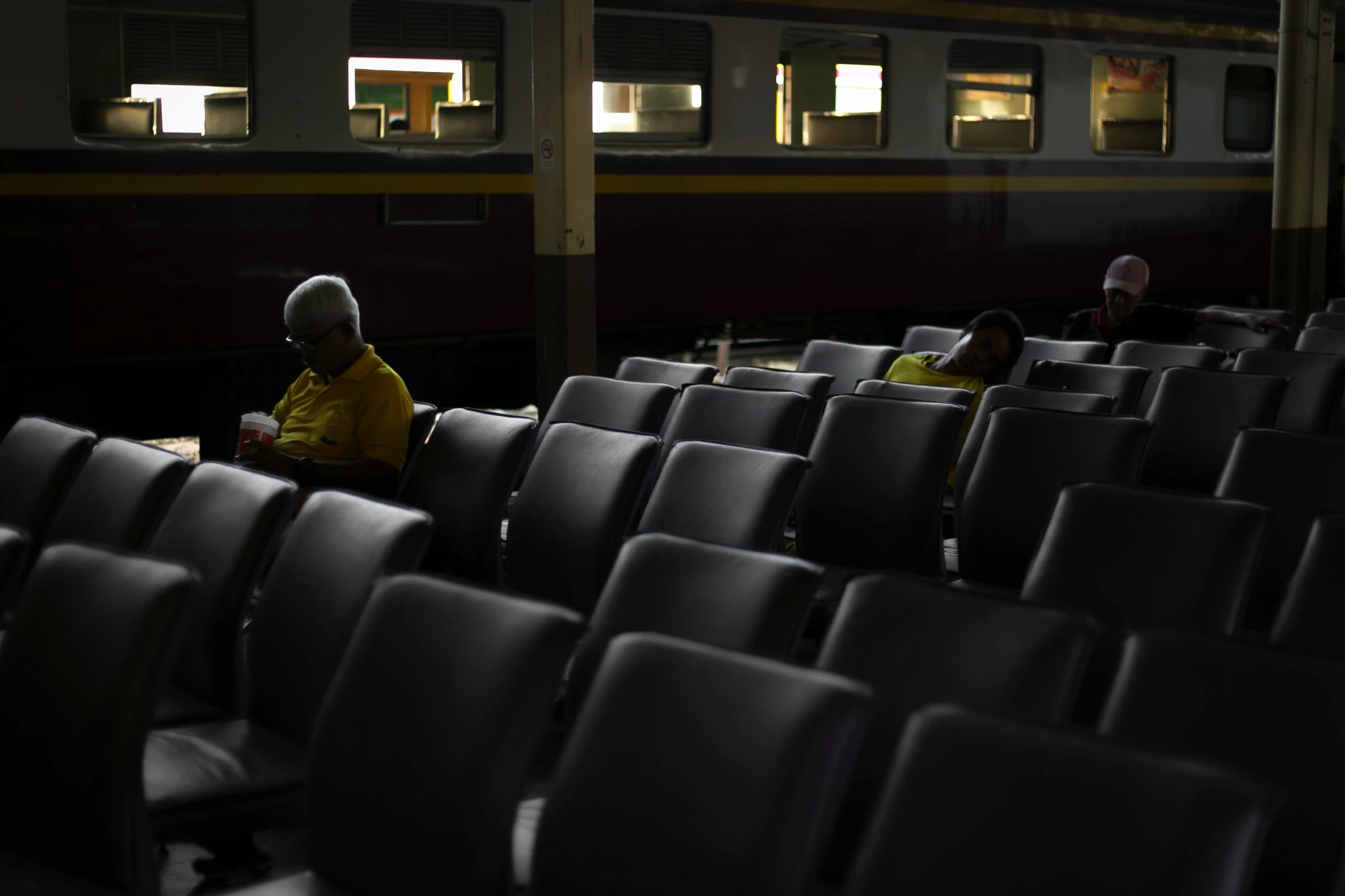 people sit on the seats in a train and look out