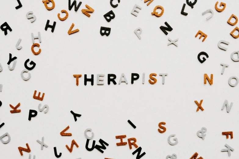 the word therapy on a white background is spelled in multiple small letters
