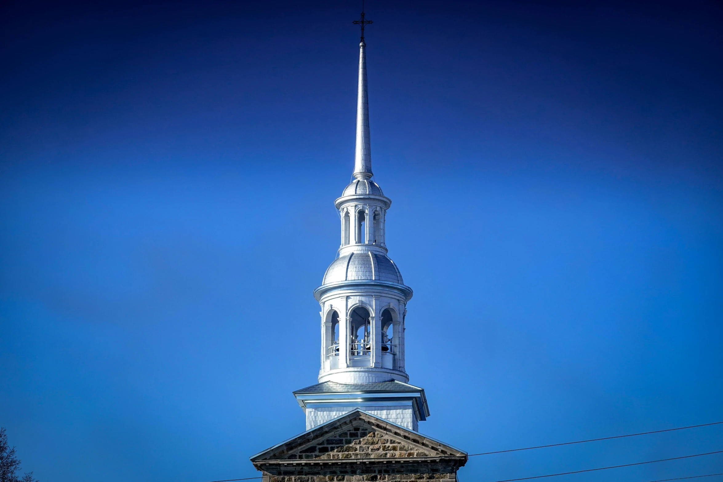 this is a steeple of a church against the blue sky