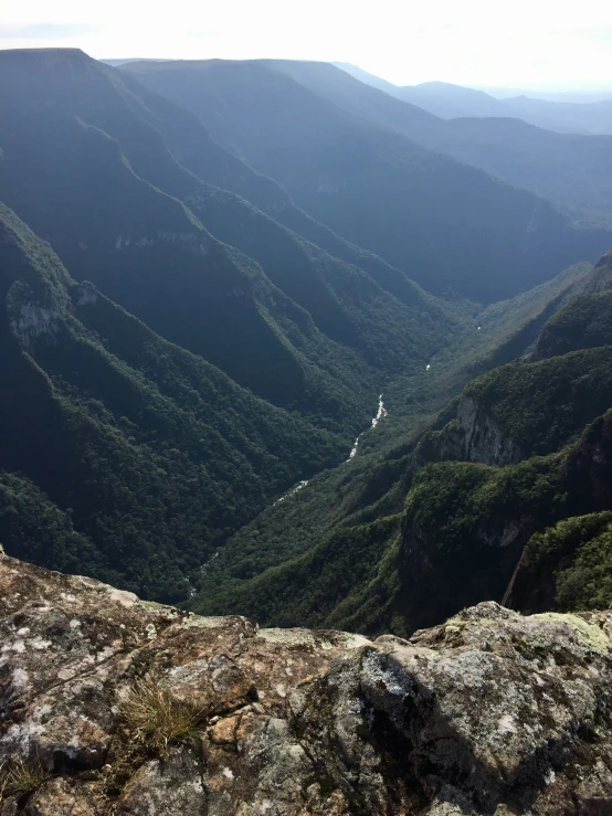 a view of a mountain river surrounded by green hills