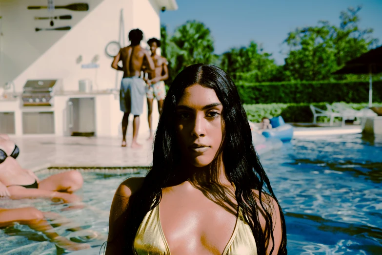 two young ladies in a swimming pool with two males