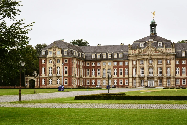 a large building with a big lawn in front