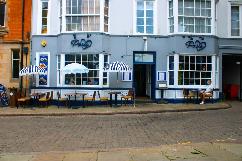 the two tables are set outside on a street corner