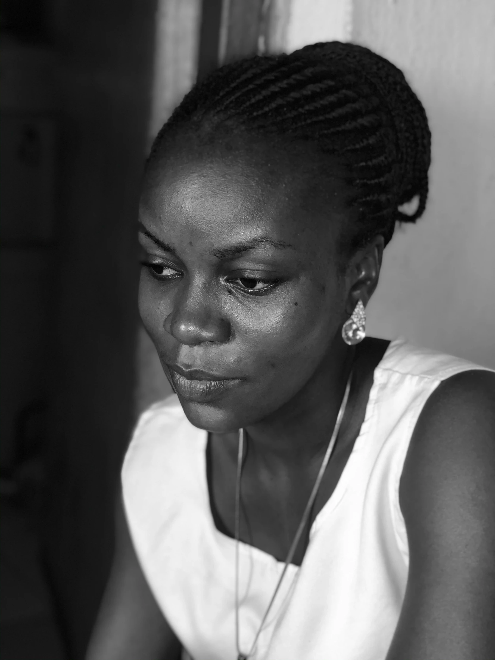 an african american woman wearing a necklace with beads