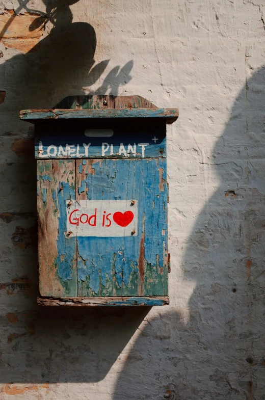 the old wall has a sign on it with a heart