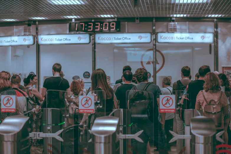 a crowd of people standing next to each other near a terminal