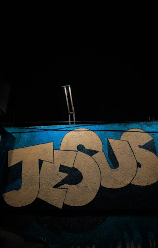a box has graffiti on it and the word jesus is in blue letters