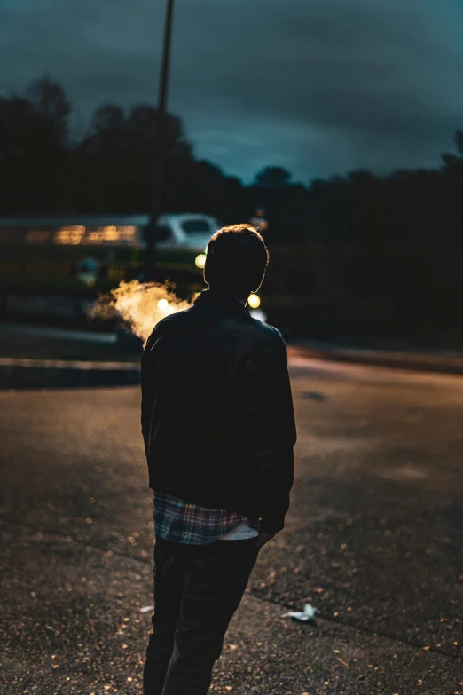 a man standing in the middle of an empty parking lot