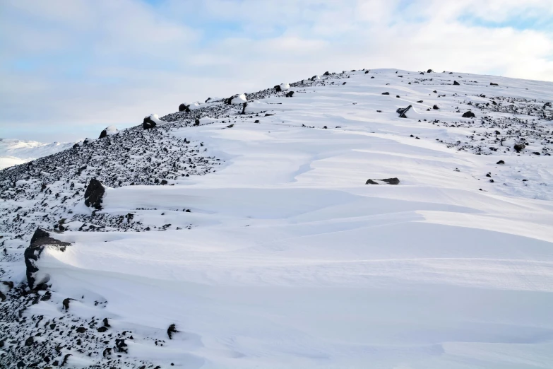 the slope has snow on it and is almost covered with snow