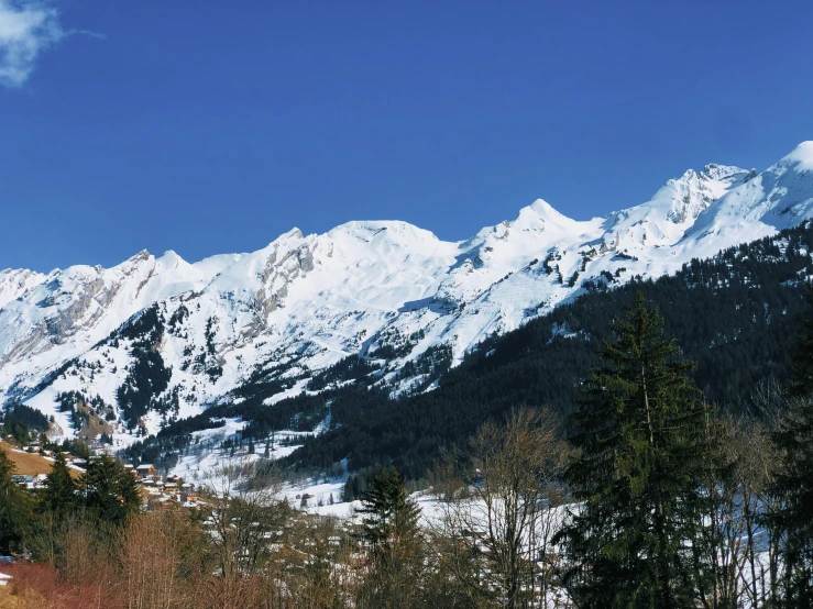 snow covered mountains with a mountain slope in the distance