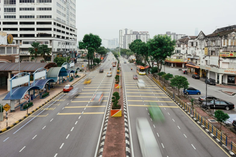 an empty city street with cars parked along both sides