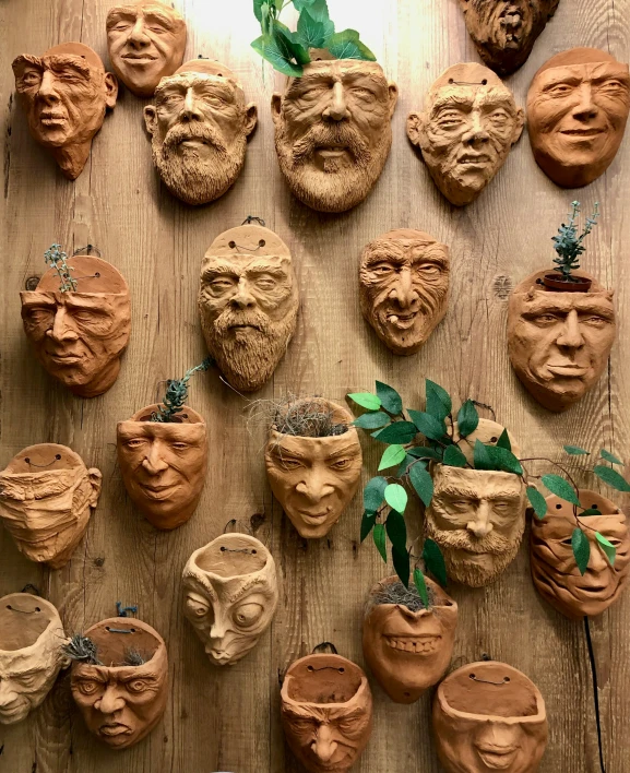 several clay heads in a wood paneled area