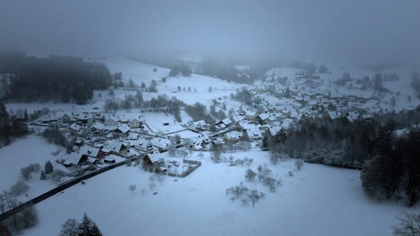 the snow has gathered on the mountains and in the middle of town