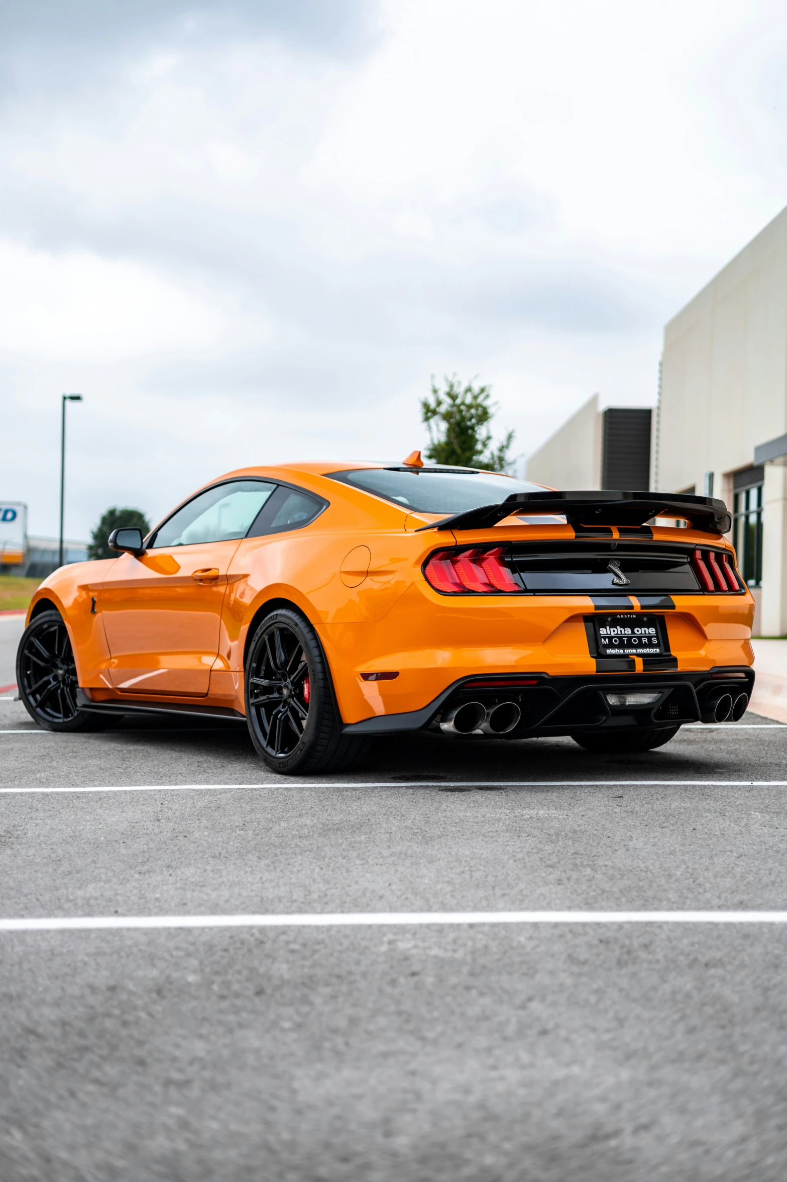 an orange sports car parked in a parking space