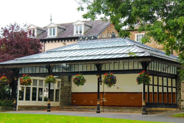 an older building with several flowers around the porch