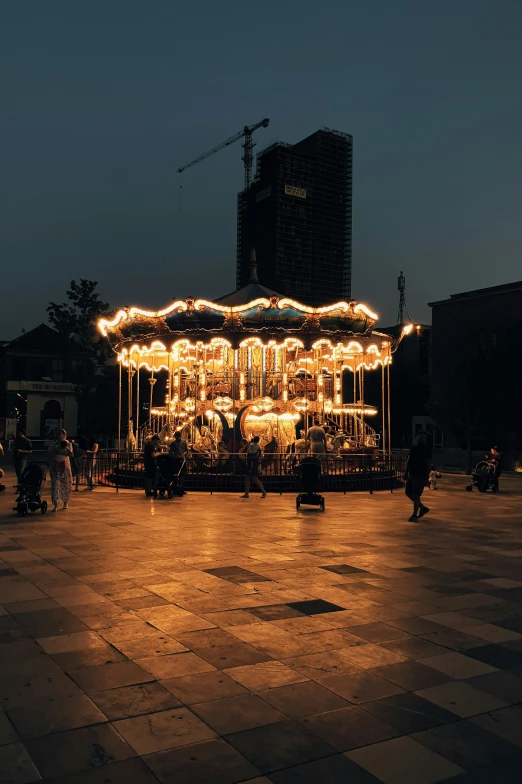 the illuminated carousel is displayed in the middle of the night