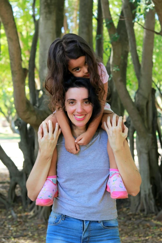 a mother with two children is holding her child