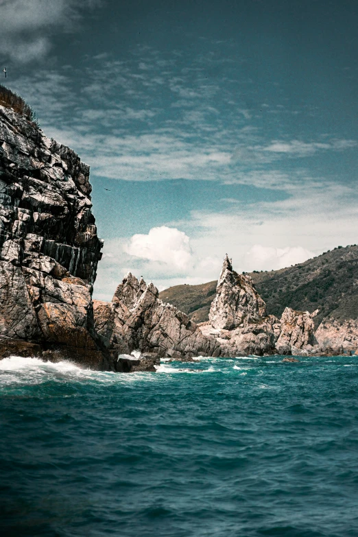 rock formations sitting at the shore of a mountain range