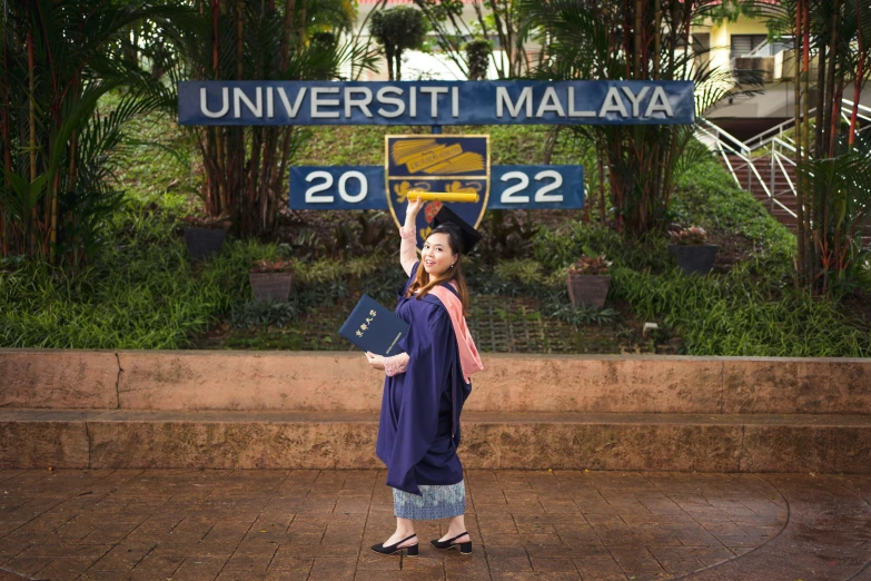 a lady in front of the university malaysia sign in malaysia