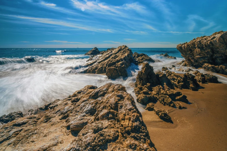 some rocks and water on the shore