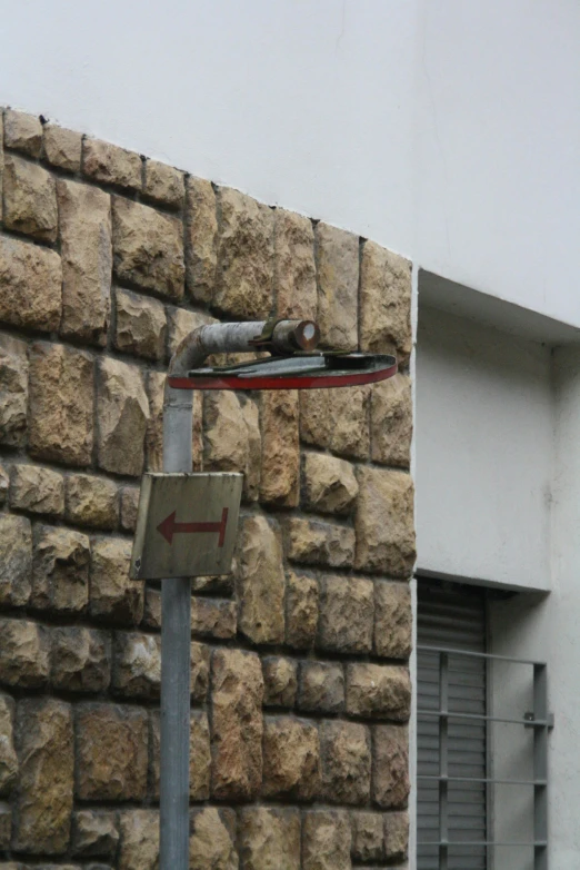 a street sign is near a brick wall