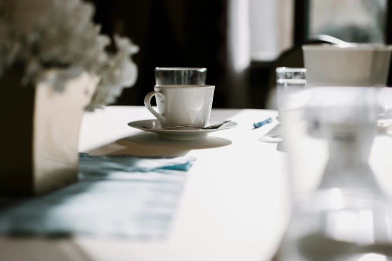 a closeup of a coffee cup, saucer and other dishes