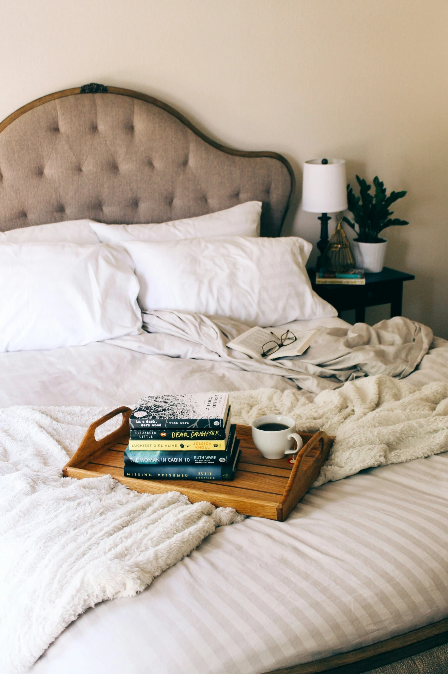 a tray with books and a cup on it