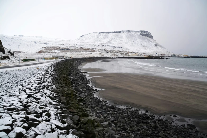 snow covered rocky beach on a cloudy day