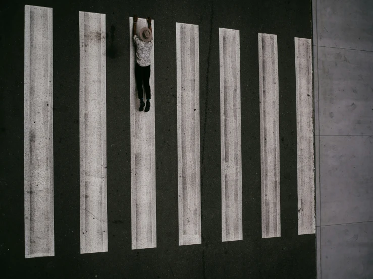 an aerial view shows a person standing at the crosswalk